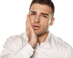Emergency Dentist Hadfield | What should you do in a dental emergency- Man with toothache and jaw pain